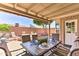 Backyard patio dining area with a fire pit and comfortable seating at 8037 W Sweetwater Ave, Peoria, AZ 85381