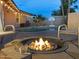 Inviting backyard featuring a fire pit, a sparkling pool and outdoor seating, perfect for relaxing and entertaining at 8037 W Sweetwater Ave, Peoria, AZ 85381