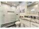 Modern bathroom features walk-in shower, granite vanity, and decorative mirror at 8037 W Sweetwater Ave, Peoria, AZ 85381