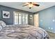 Relaxing bedroom with modern decor, natural light, and a ceiling fan at 8037 W Sweetwater Ave, Peoria, AZ 85381