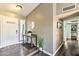 Warm and inviting entryway with hardwood floors, a stylish console table, and a view into the home's interior at 8037 W Sweetwater Ave, Peoria, AZ 85381