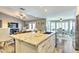 Bright kitchen with granite countertops, stainless steel appliances, and an island, seamlessly connecting the kitchen to the living room at 8037 W Sweetwater Ave, Peoria, AZ 85381