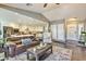 Cozy living room featuring a comfortable leather sofa, open layout, and seamless flow into the kitchen at 8037 W Sweetwater Ave, Peoria, AZ 85381