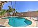 Backyard pool with landscaped surroundings, hammock, and basketball hoop at 8037 W Sweetwater Ave, Peoria, AZ 85381