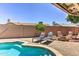 Backyard pool with lounge chairs and a fire pit at 8037 W Sweetwater Ave, Peoria, AZ 85381