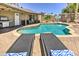 Inviting backyard pool area with chaise lounges for relaxing at 8037 W Sweetwater Ave, Peoria, AZ 85381