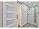 Renovated bathroom with a tiled shower, glass door, and sliding barn door at 8151 E Del Joya Dr, Scottsdale, AZ 85258