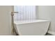 Modern freestanding tub with window view offers a serene bathing experience at 8151 E Del Joya Dr, Scottsdale, AZ 85258