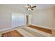 Bright bedroom featuring light wood floors, neutral walls, and a ceiling fan at 8151 E Del Joya Dr, Scottsdale, AZ 85258