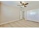 Bright bedroom featuring light wood floors, neutral walls, and a ceiling fan at 8151 E Del Joya Dr, Scottsdale, AZ 85258