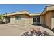 Backyard patio area with dual sliding glass doors and desert landscaping at 8151 E Del Joya Dr, Scottsdale, AZ 85258