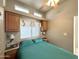 Bedroom with built in storage, a queen sized bed, overhead fan with lights, and dual side lamps at 944 S Nickel Dr, Apache Junction, AZ 85119