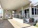 Spacious carport leads to a charming porch and inviting entrance of a manufactured home at 944 S Nickel Dr, Apache Junction, AZ 85119