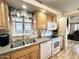 Kitchen showcasing stainless steel double sink, white appliances, granite counters and ample wood cabinet storage at 944 S Nickel Dr, Apache Junction, AZ 85119