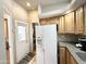 Kitchen showing the full sized white refrigerator, and the kitchen sink and cabinetry accessing to the outside at 944 S Nickel Dr, Apache Junction, AZ 85119