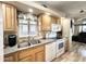 Well-lit kitchen featuring wood cabinets, granite-look countertops, and white appliances at 944 S Nickel Dr, Apache Junction, AZ 85119