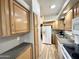 Galley kitchen featuring wood cabinets, white appliances, and granite-look countertops at 944 S Nickel Dr, Apache Junction, AZ 85119