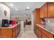 Modern kitchen showcasing granite countertops, wooden cabinetry, and open layout to the living area at 10122 E Michigan Ave # 19, Sun Lakes, AZ 85248