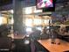 Interior of the restaurant with tables, chairs, TVs, and sports decor at 10122 E Michigan Ave # 19, Sun Lakes, AZ 85248