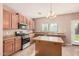 Well-equipped kitchen featuring wood cabinets, stainless steel appliances, and center island at 11718 N 152Nd Dr, Surprise, AZ 85379