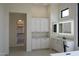 Elegant bathroom featuring vanity, walk-in closet access, and large mirror, offering comfort and style at 12856 E Rosewood Dr, Scottsdale, AZ 85255
