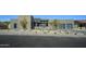 Contemporary home's exterior shows natural stone accents, desert landscaping, and a modern design at 12856 E Rosewood Dr, Scottsdale, AZ 85255