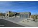 Modern exterior showcasing a contemporary home with a paver driveway and desert landscaping under a blue sky at 12856 E Rosewood Dr, Scottsdale, AZ 85255