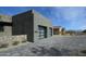 Contemporary home exterior shows a gray stucco facade with a spacious two-car garage and modern glass doors at 12856 E Rosewood Dr, Scottsdale, AZ 85255