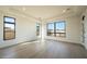 Bright living room features large windows, hardwood floors, and neutral tones, perfect for entertaining at 12856 E Rosewood Dr, Scottsdale, AZ 85255