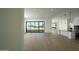 Bright living area with hardwood floors, a sliding glass door to the backyard, and a view into the kitchen area at 12856 E Rosewood Dr, Scottsdale, AZ 85255