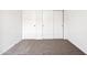 Vacant bedroom showcasing carpet flooring, white walls, and closet with white doors at 1317 S Vista Ave, Florence, AZ 85132