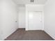 Cozy bedroom with plush neutral carpet, bright white walls, and closet space at 1317 S Vista Ave, Florence, AZ 85132