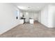 Open-concept living space featuring a kitchen with white cabinets and an island at 1317 S Vista Ave, Florence, AZ 85132