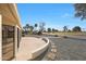 The stone and brick patio is surrounded by a rock yard with golf course view at 13443 W Gable Hill Dr, Sun City West, AZ 85375