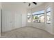 Bright bedroom with large windows and closet, showcasing natural light at 1425 S Lindsay Rd # 18, Mesa, AZ 85204