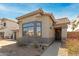 Inviting single-story home with desert landscaping, cozy bay window and front door at 1425 S Lindsay Rd # 18, Mesa, AZ 85204