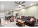 Open-concept living room with ceiling fan open to the adjacent dining area at 1505 N Center St # 132, Mesa, AZ 85201