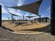 Modern community playground featuring shaded play areas and updated equipment under a clear sky at 15653 W Deanne Dr, Waddell, AZ 85355