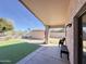 View of back patio with turf grass, shed and privacy fence at 1624 W Minton St, Phoenix, AZ 85041