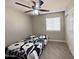 This bedroom features a black and white comforter and a ceiling fan at 1624 W Minton St, Phoenix, AZ 85041