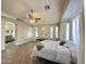 This bright room features a decorative ceiling fan, piano, and a full size bed with white comforter at 1624 W Minton St, Phoenix, AZ 85041