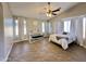 The room features a decorative ceiling fan, piano, and a full size bed with white comforter at 1624 W Minton St, Phoenix, AZ 85041