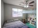 Bedroom featuring bunkbeds, a full sized bed, lots of natural light, and colorful decorations and green rug at 1624 W Minton St, Phoenix, AZ 85041