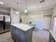 This kitchen has an island with white marble countertop, stylish lights, and stainless steel appliances at 1624 W Minton St, Phoenix, AZ 85041