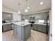 Bright kitchen with gray cabinets, quartz countertops, stainless appliances, and modern pendant lighting at 1624 W Minton St, Phoenix, AZ 85041