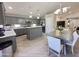 Well-lit eat-in kitchen features gray cabinetry, stainless appliances, and a cozy dining area at 1624 W Minton St, Phoenix, AZ 85041