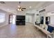 Spacious living room with tiled floors, high ceilings, ceiling fan, and neutral paint at 1624 W Minton St, Phoenix, AZ 85041