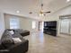 Inviting living room with tile flooring, large windows, ceiling fan, and comfortable seating at 1624 W Minton St, Phoenix, AZ 85041