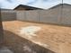 Backyard area with dirt, enclosed by a tall block wall for privacy at 17426 W Eva St, Waddell, AZ 85355