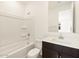 Bathroom featuring modern fixtures, including a vanity with cabinetry and a bathtub at 17426 W Eva St, Waddell, AZ 85355